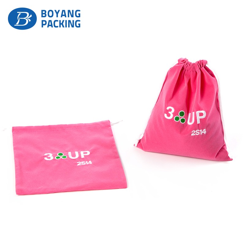 Pink velvet drawstring pouch with embroidered logo